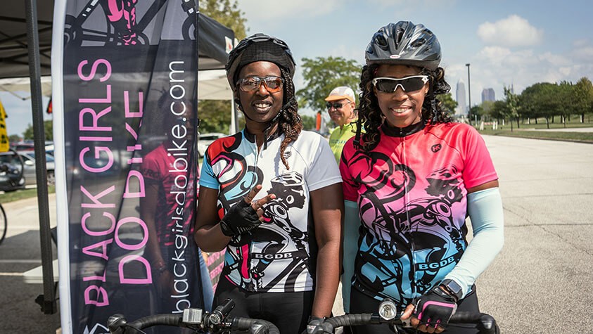 Two cyclists smile at the camera after finishing a Black Girls Do Bike ride.