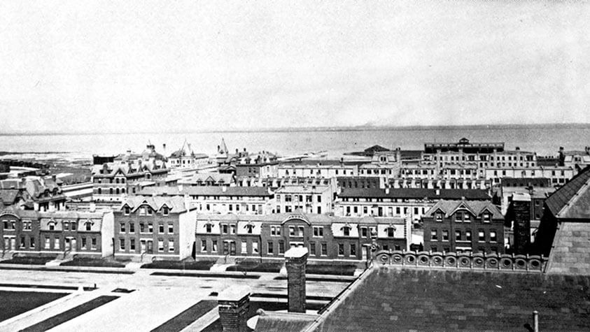 An historic black and white photo shows factory townhouses adjacent to Big Marsh circa eighteen eighty.