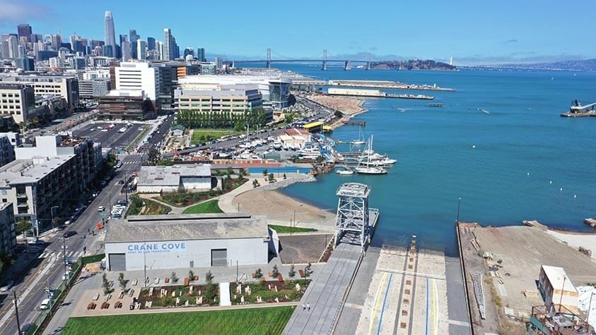 An aerial view of Crane Cove Park, with the Golden Gate Bridge in the distance.