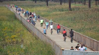 Walkers, runners and cyclist share space on boardwalks built to protect the East Coast Greenway.